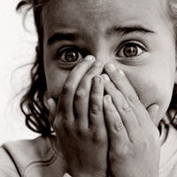 Nervous girl with heads over her mouth in blakc and white